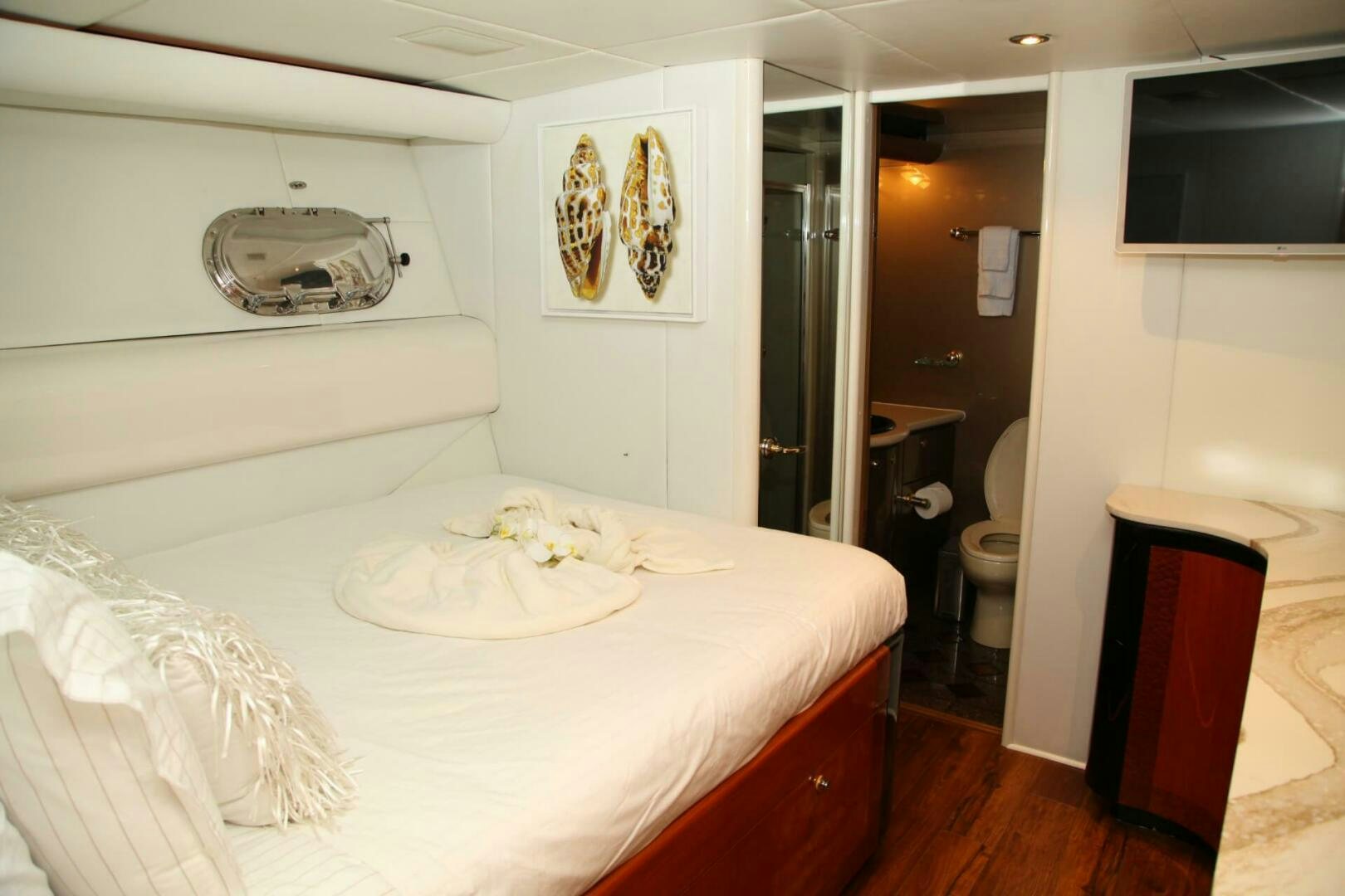 a bedroom with a bed and a mirror aboard CHASER - BEING OFFERED ON A 50% PARTNERSHIP BASIS Yacht for Sale