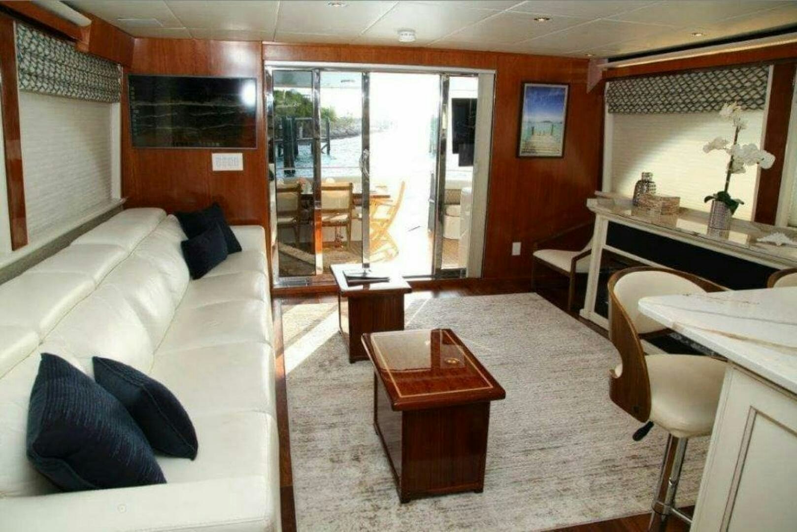 a living room with a glass door aboard CHASER - BEING OFFERED ON A 50% PARTNERSHIP BASIS Yacht for Sale