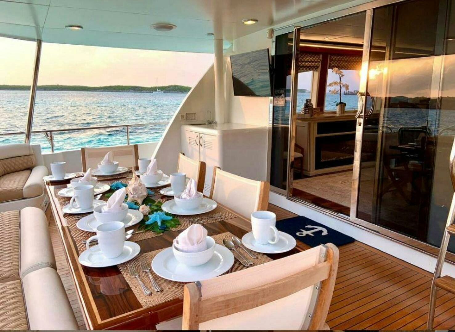 a table with cups and plates on it aboard CHASER - BEING OFFERED ON A 50% PARTNERSHIP BASIS Yacht for Sale