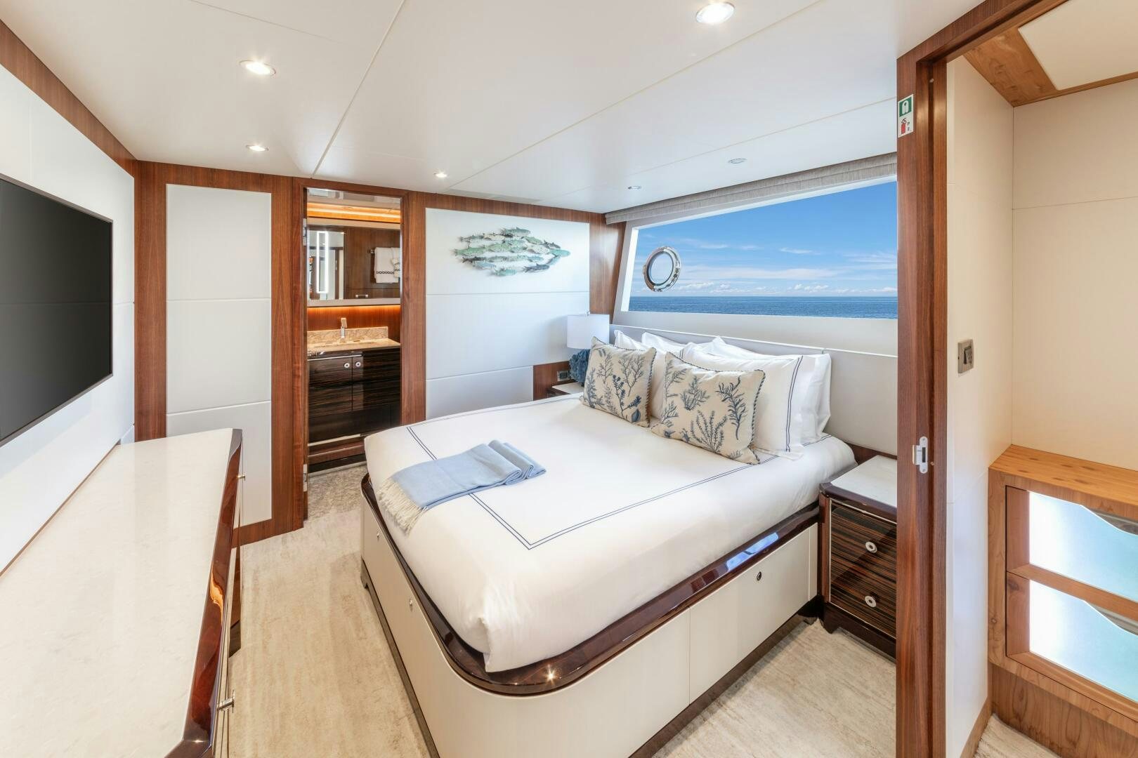 a bedroom with a bed and a tv aboard DRINKABILITY Yacht for Sale
