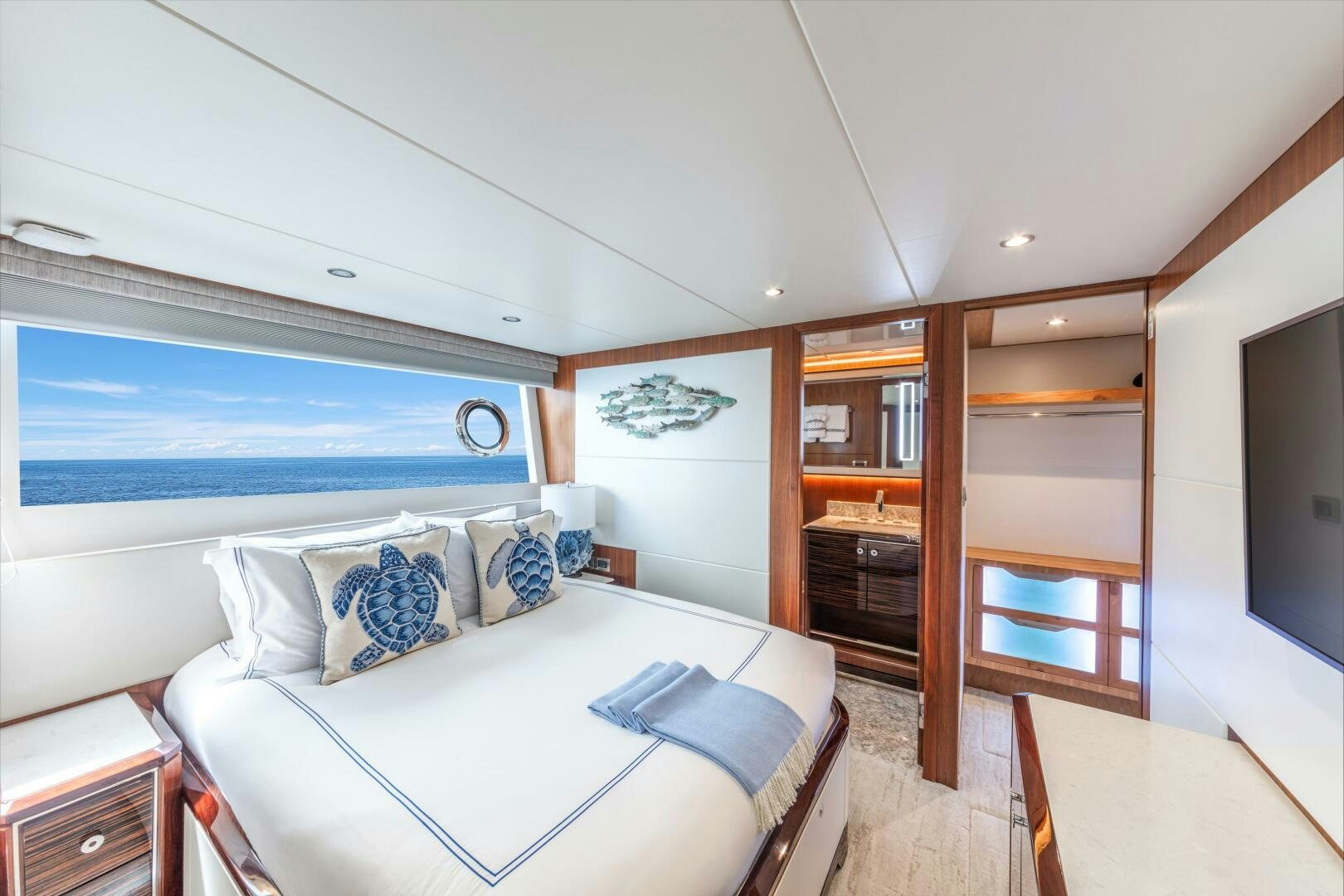 a bedroom with a bed and a closet aboard DRINKABILITY Yacht for Sale