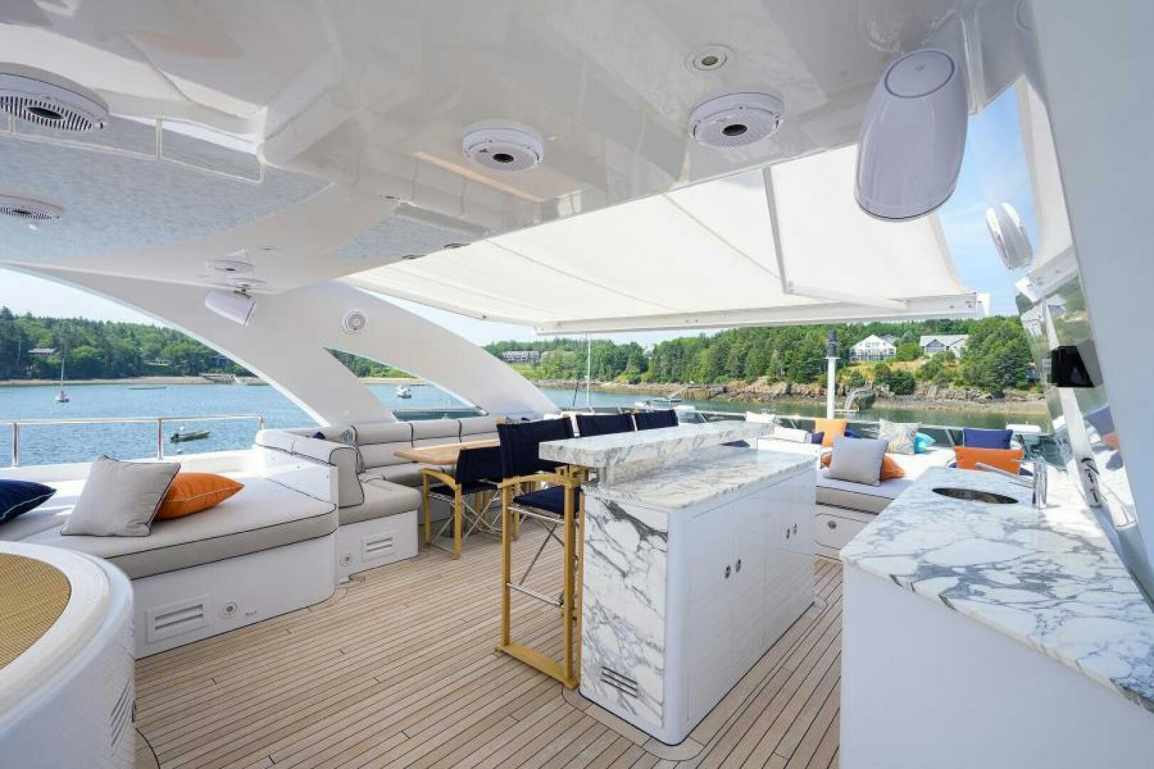 a room with a large white bed and a large white table with chairs aboard CASTLEFINN Yacht for Sale