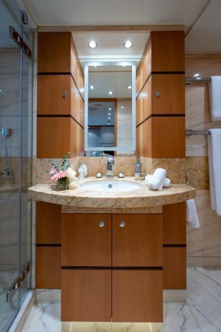 a bathroom with a sink and mirror aboard CASTLEFINN Yacht for Sale