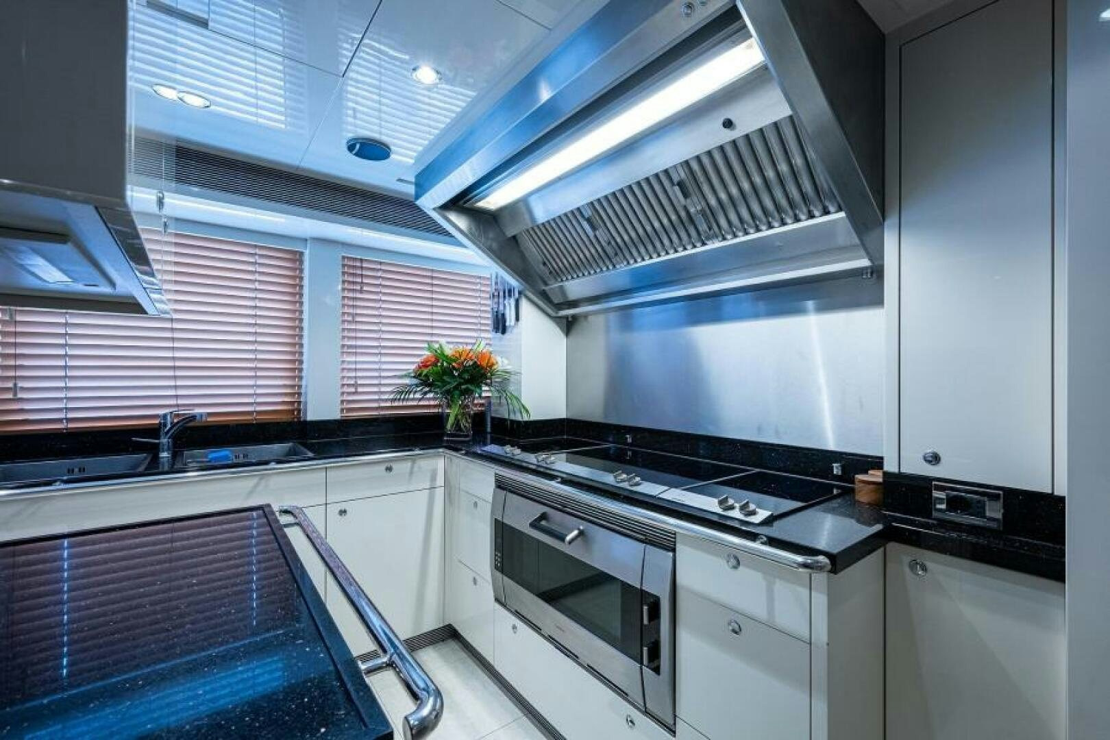 a kitchen with a stove and a vent aboard CASTLEFINN Yacht for Sale