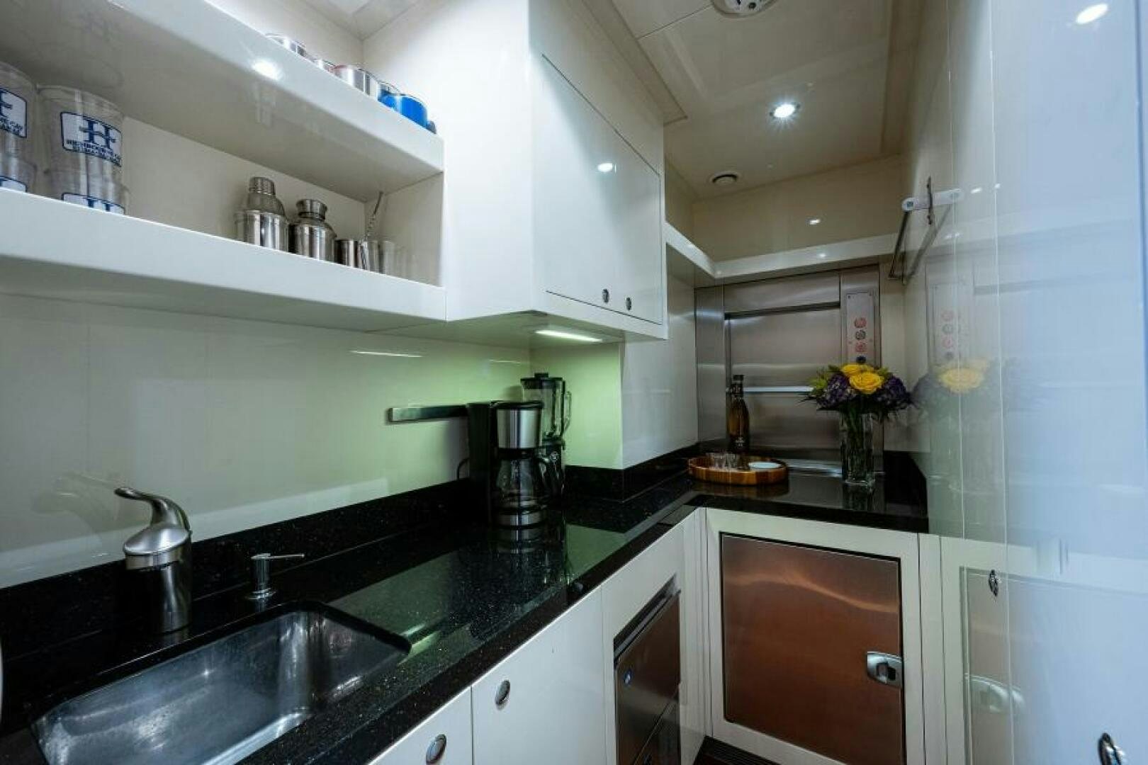 a kitchen with white cabinets aboard CASTLEFINN Yacht for Sale