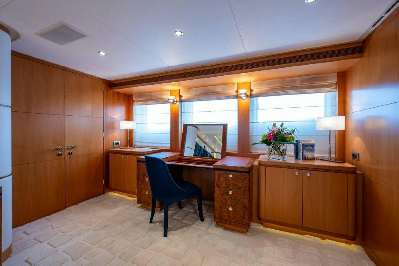 a room with wooden cabinets and a chair aboard CASTLEFINN Yacht for Sale