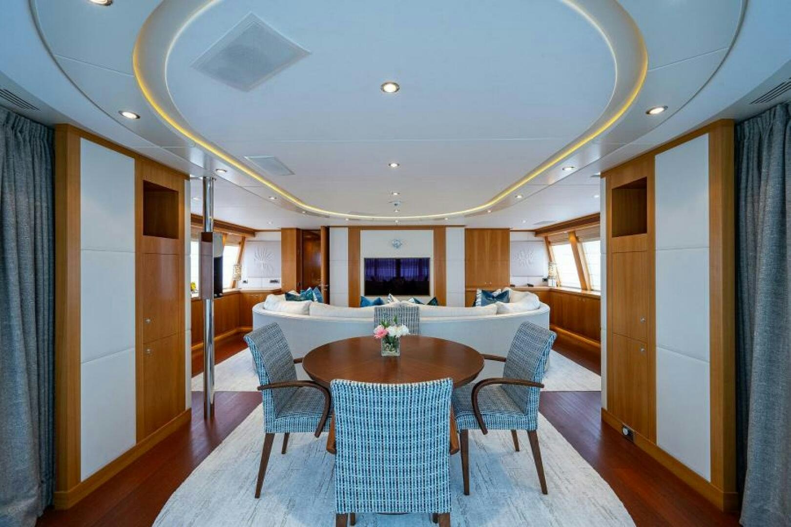 a large room with a table and chairs aboard CASTLEFINN Yacht for Sale