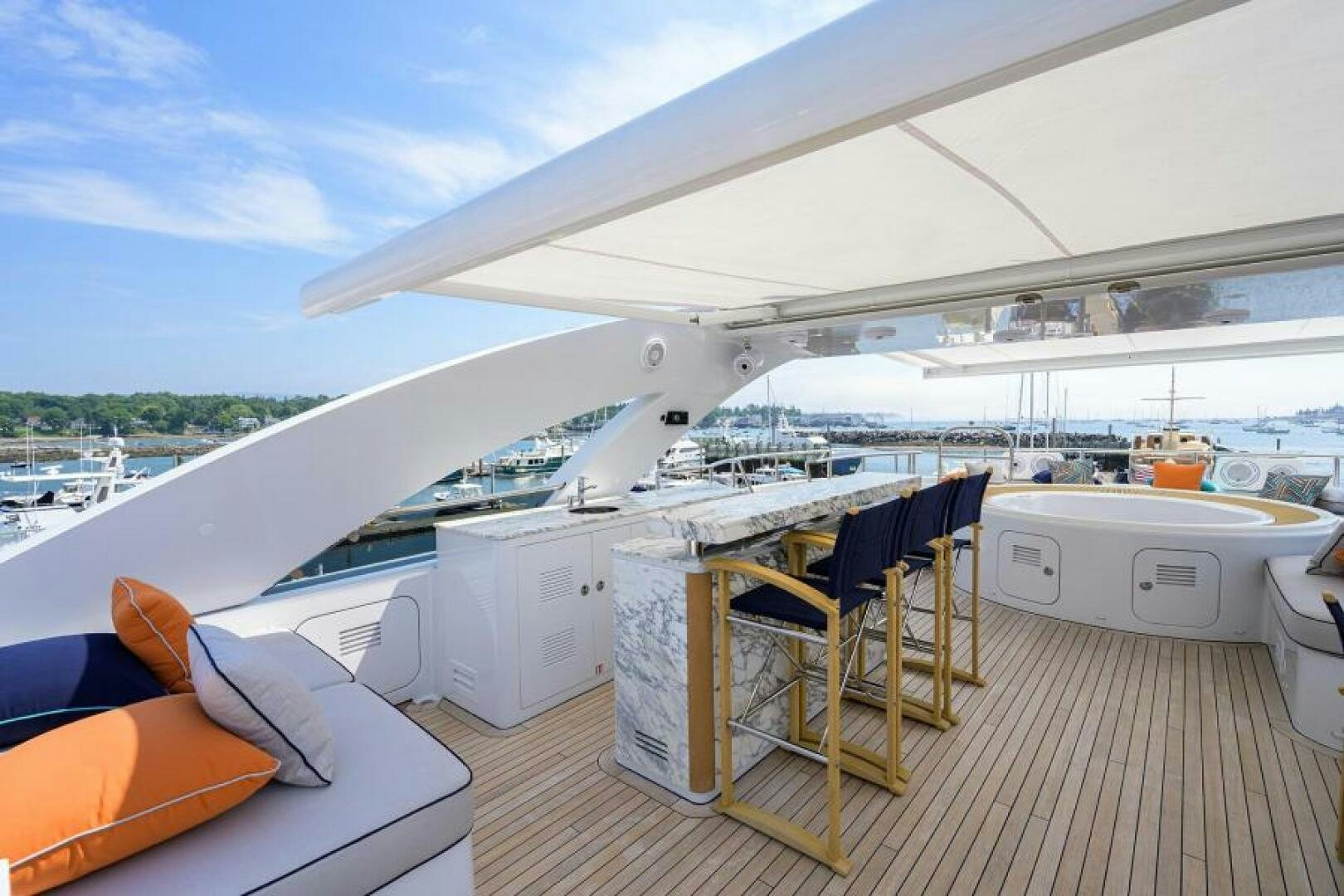 a deck with a view of the water and boats aboard CASTLEFINN Yacht for Sale