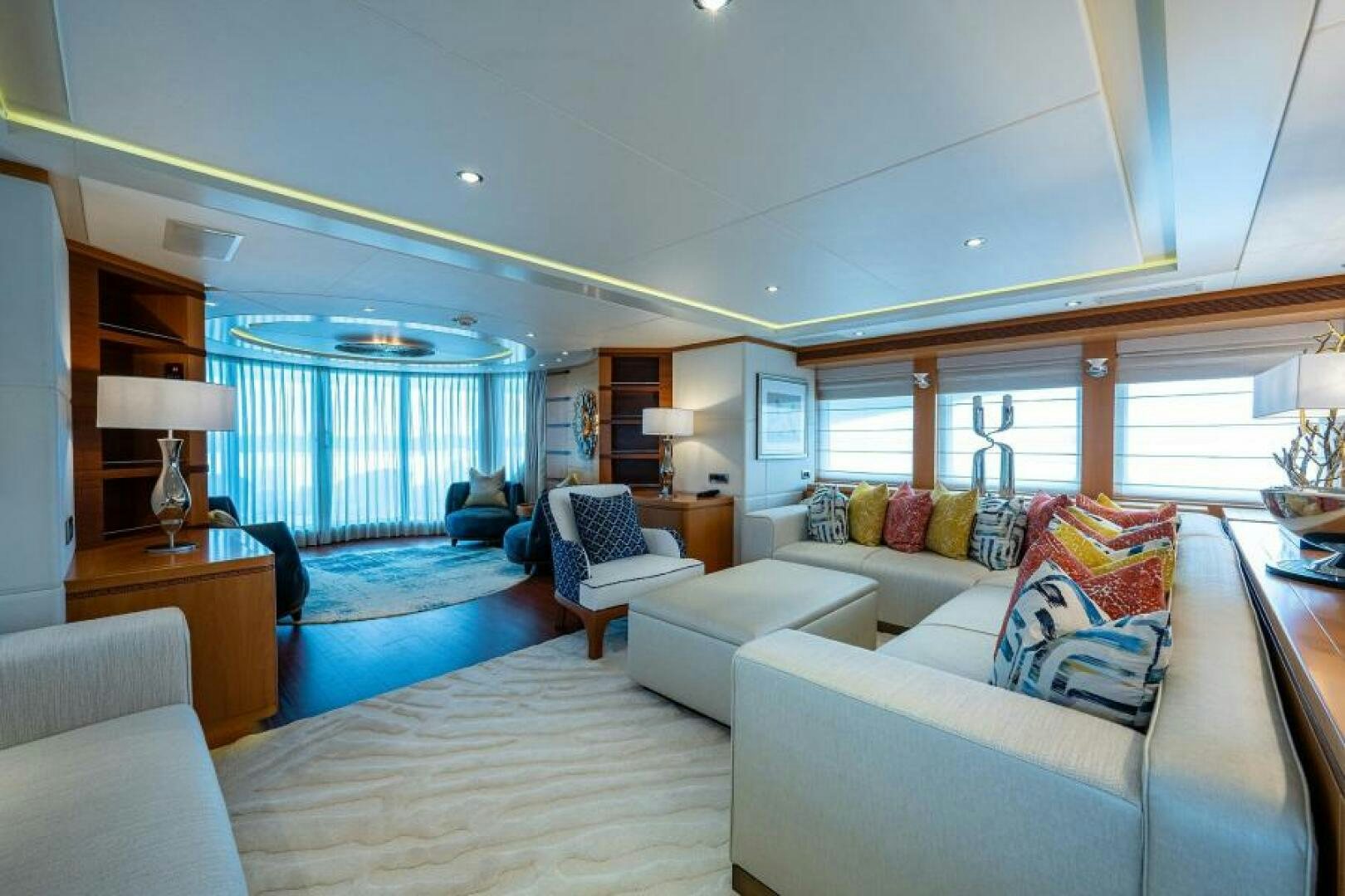 a large living room with a large blue and white rug aboard CASTLEFINN Yacht for Sale