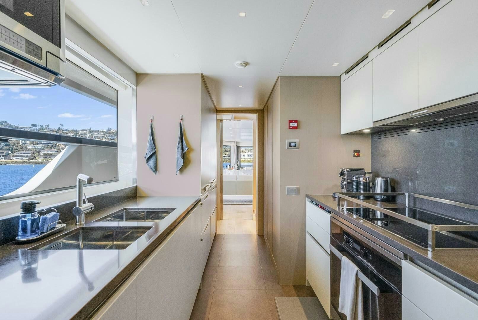 a kitchen with a large window aboard GENOA Yacht for Sale