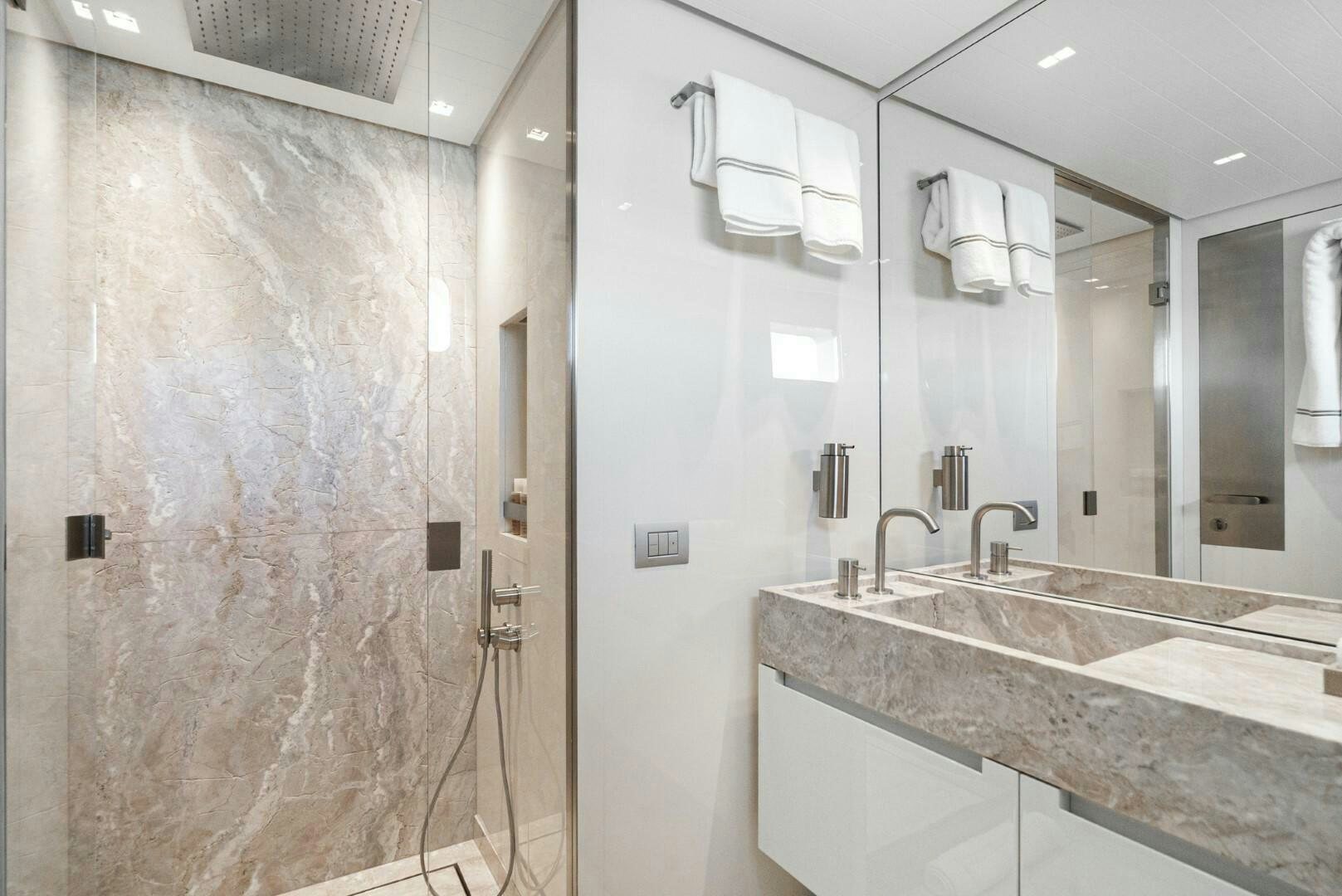 a bathroom with a sink and a mirror aboard GENOA Yacht for Sale