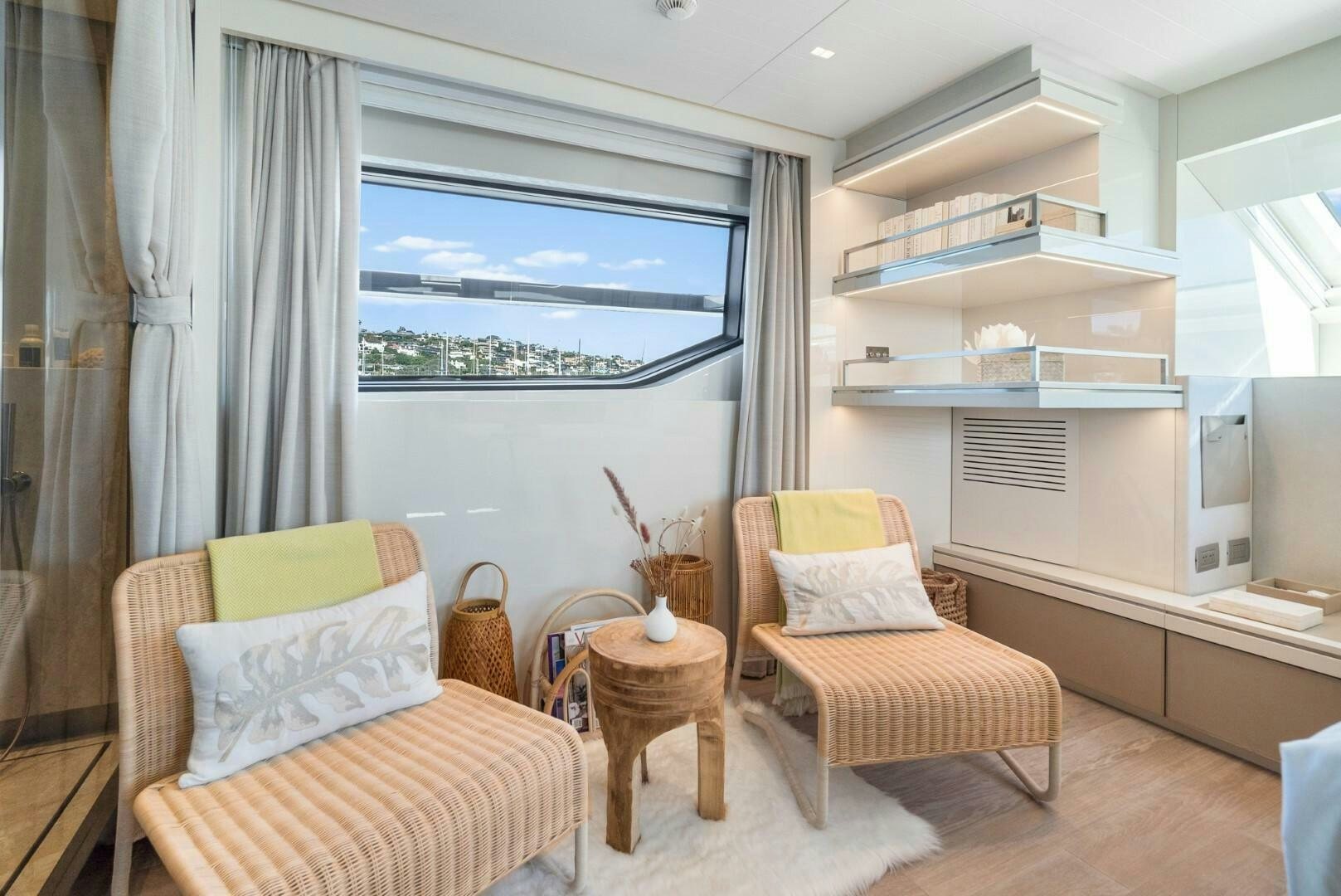 a room with a couch and a table and a window aboard GENOA Yacht for Sale