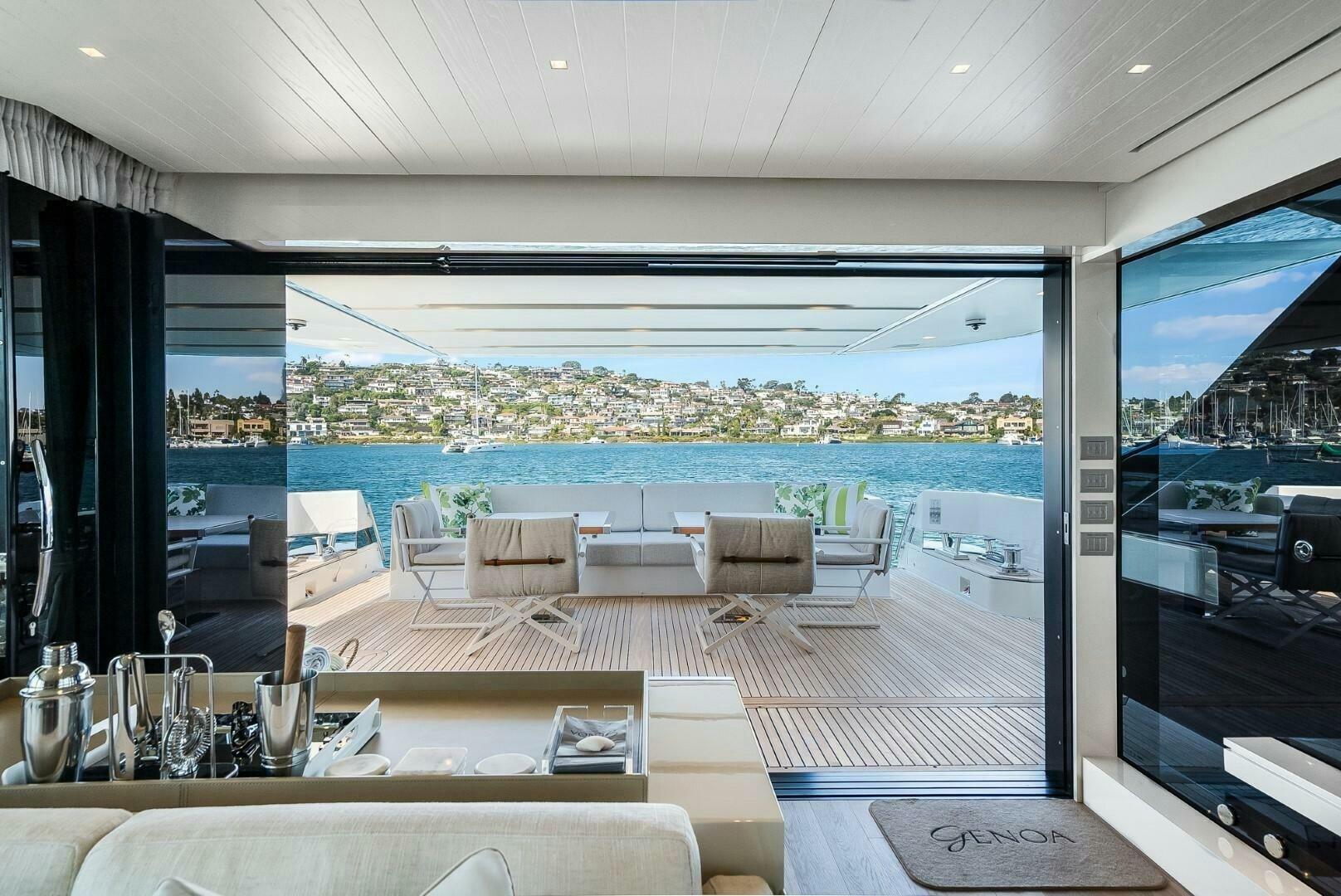a room with a table chairs and a view of the city aboard GENOA Yacht for Sale