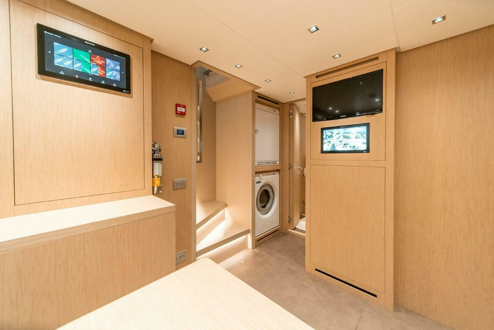 a room with a bed and a tv on the wall aboard GENOA Yacht for Sale