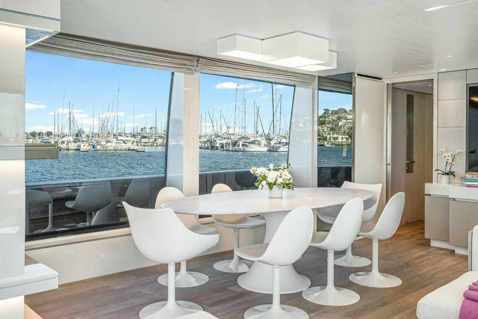 a room with a table and chairs aboard GENOA Yacht for Sale