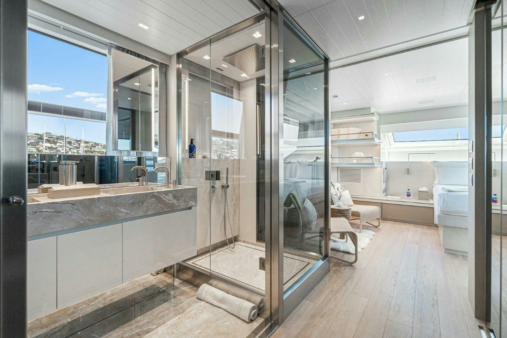 a large bathroom with glass walls aboard GENOA Yacht for Sale