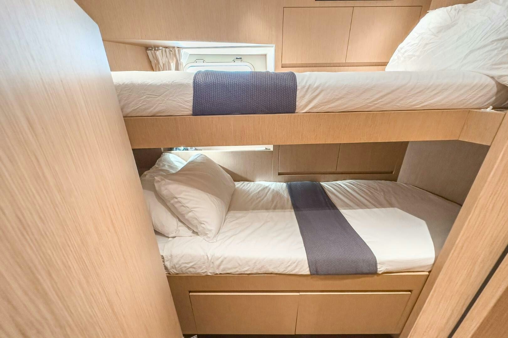 a bed with white sheets aboard GENOA Yacht for Sale