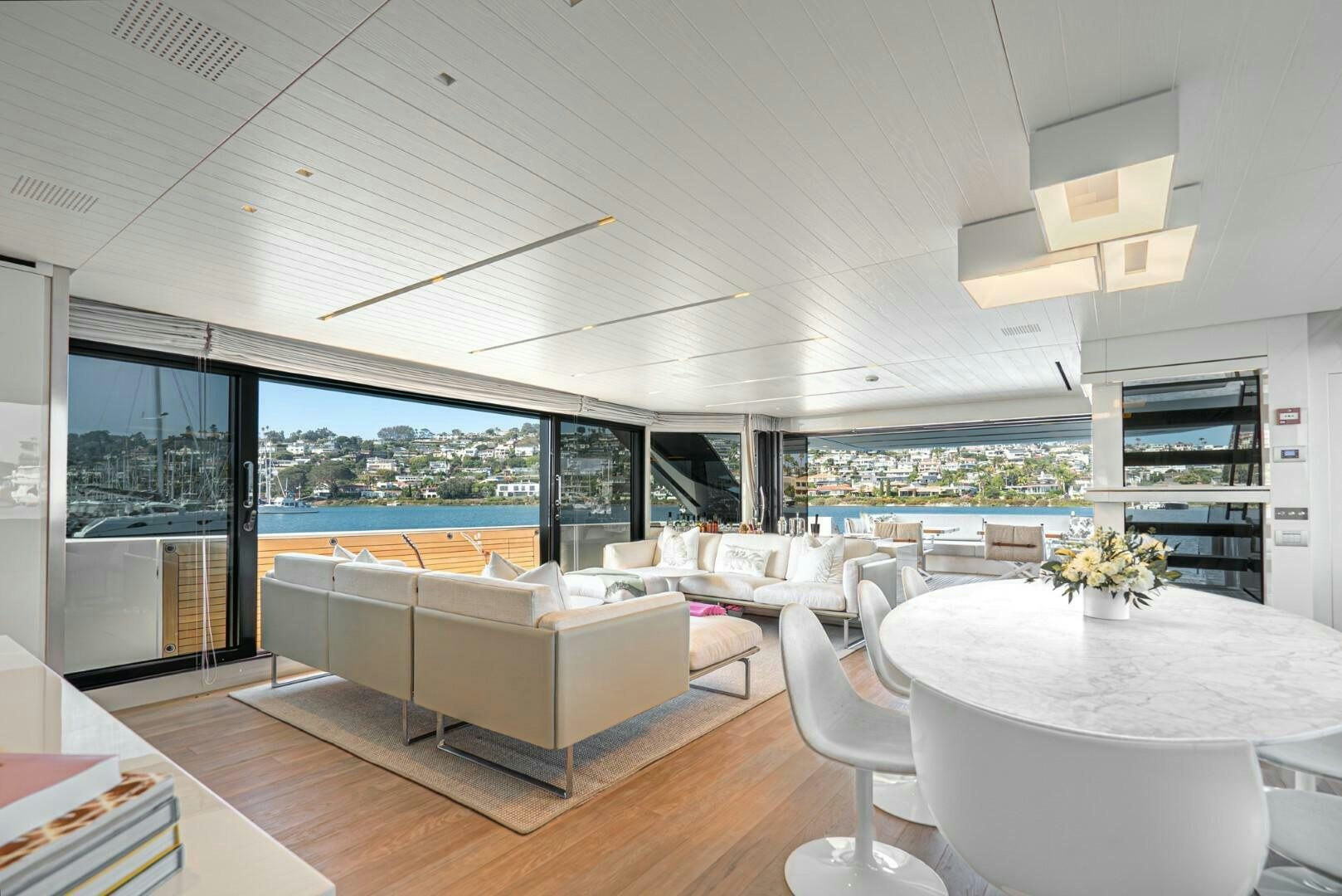 a living room with a large window aboard GENOA Yacht for Sale
