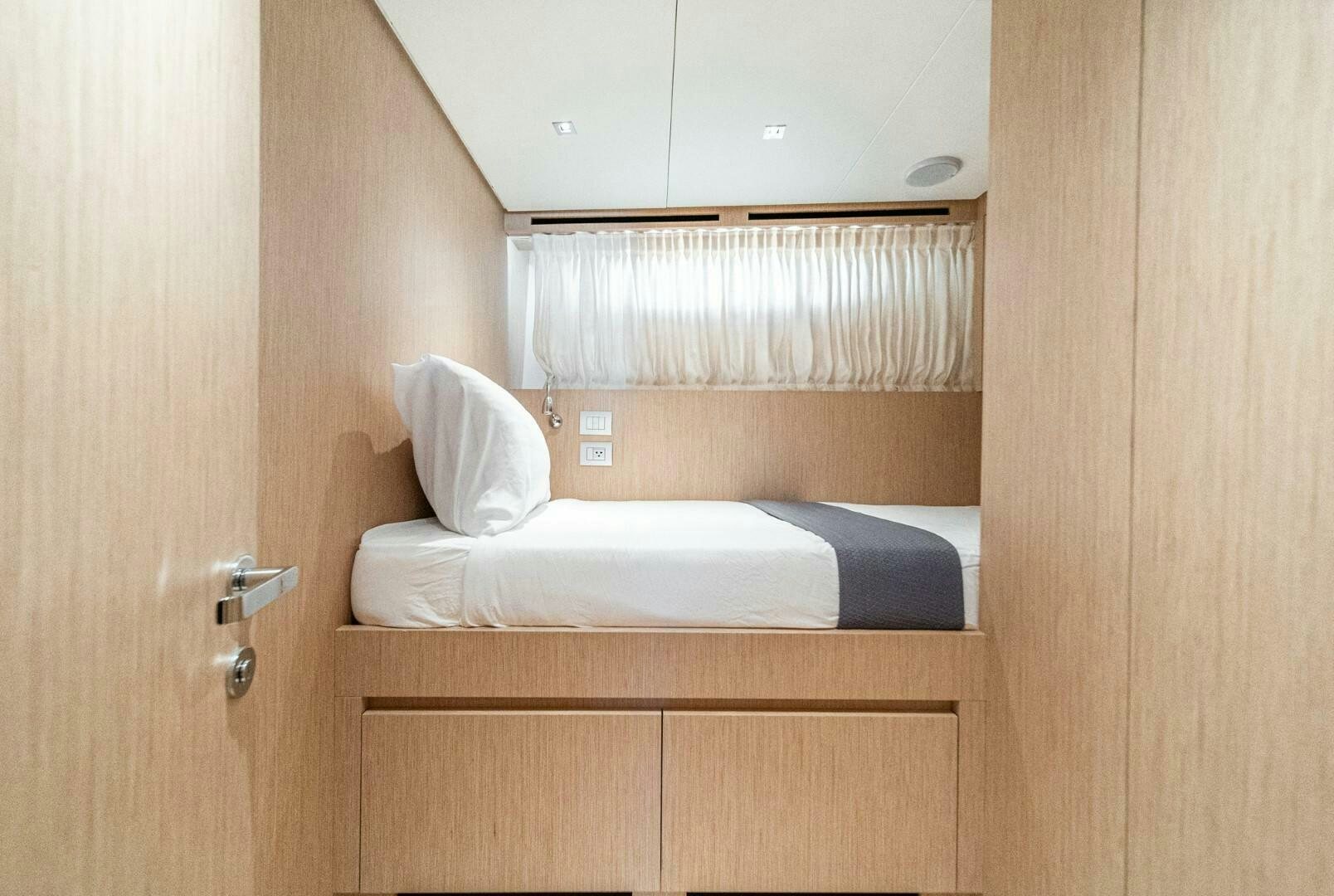 a room with a bed and a window aboard GENOA Yacht for Sale
