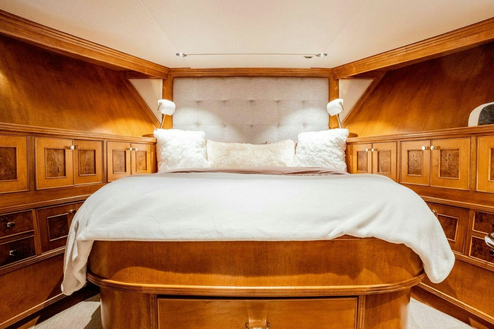 a bed with white sheets aboard DOZER Yacht for Sale