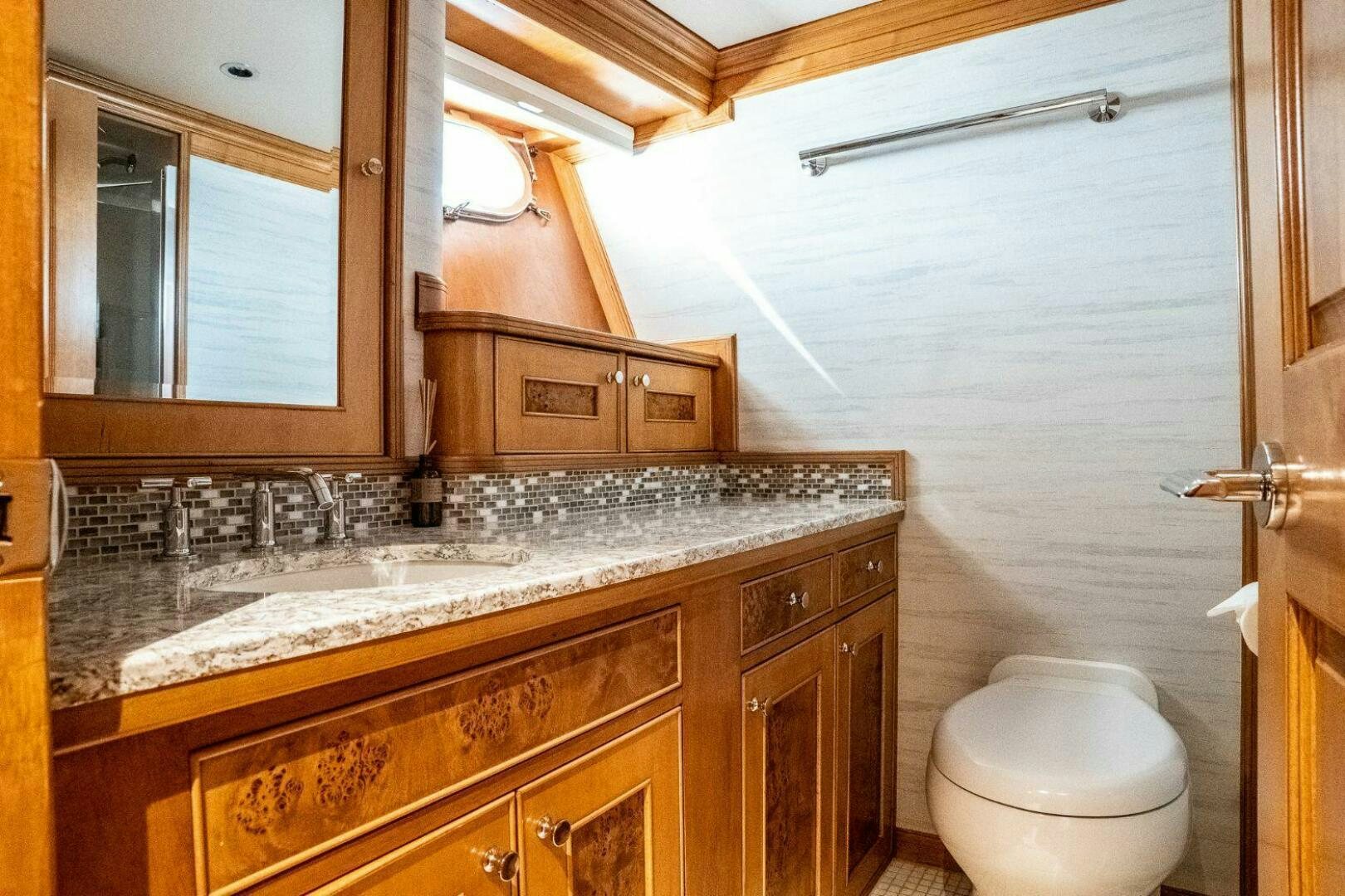 a bathroom with a marble counter top aboard DOZER Yacht for Sale