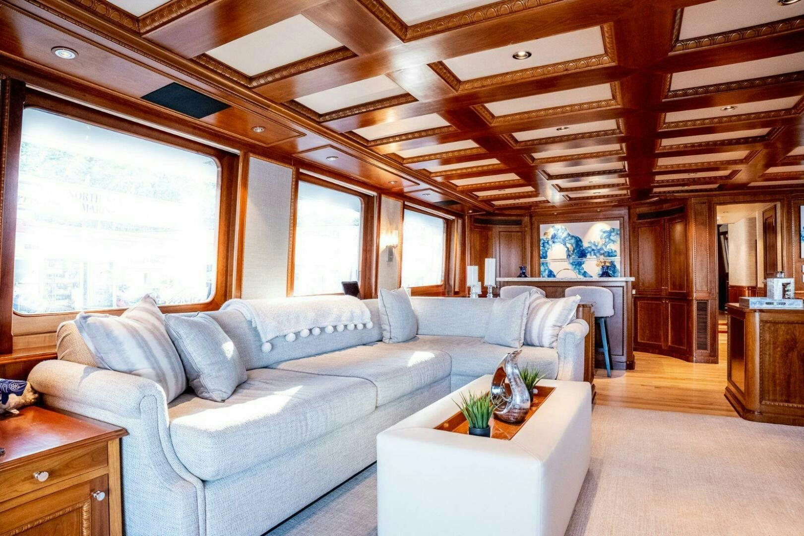 a living room with a large sectional sofa aboard DOZER Yacht for Sale