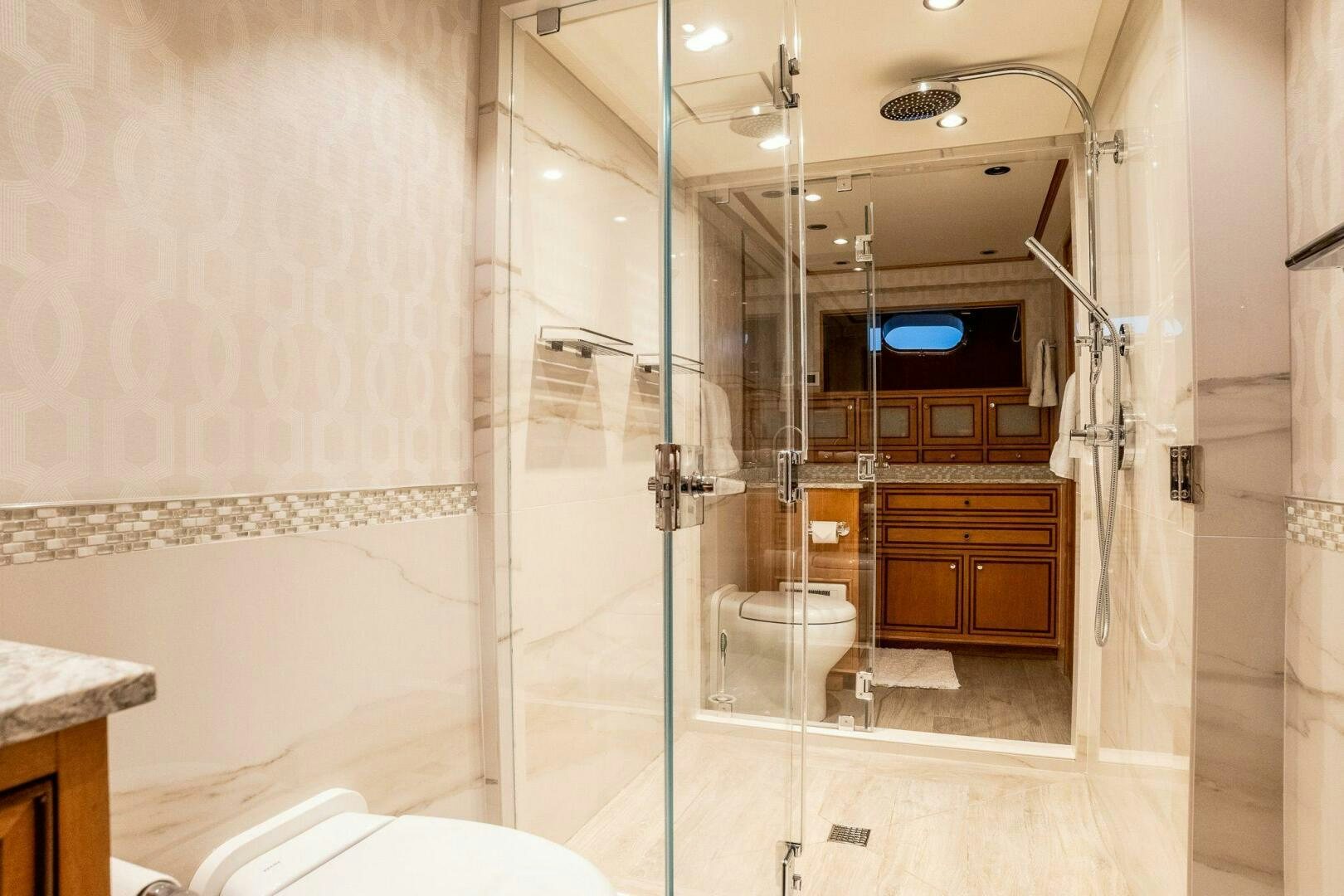 a bathroom with a glass shower aboard DOZER Yacht for Sale