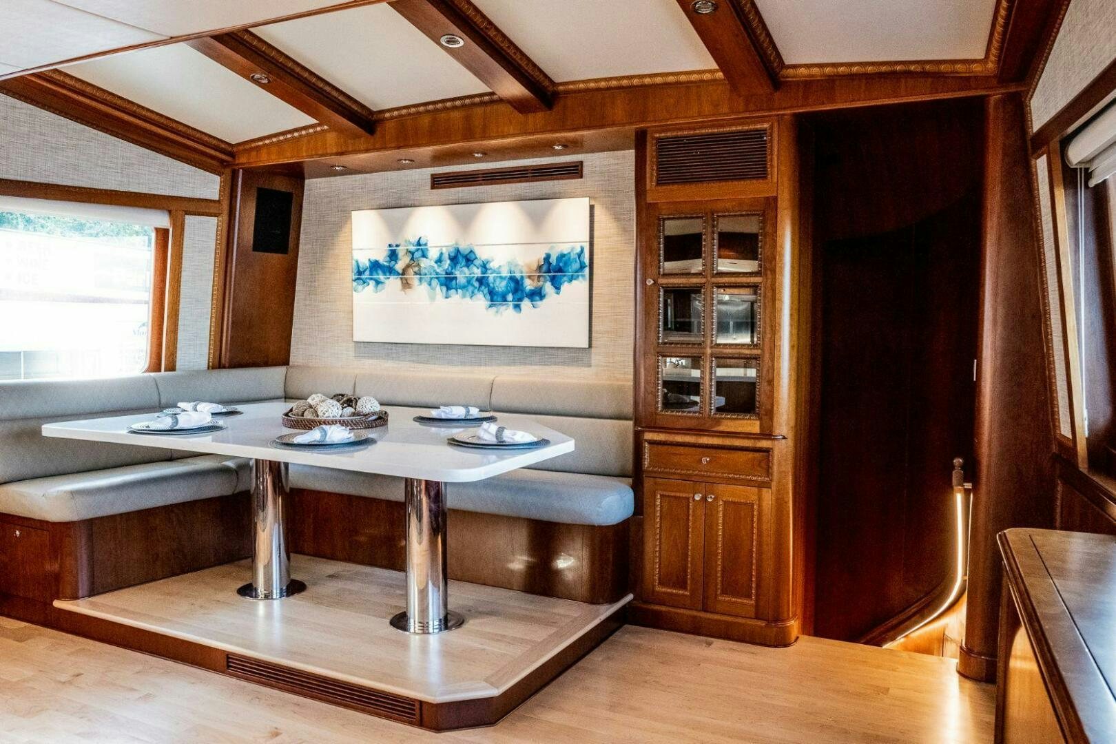 a room with a table and chairs aboard DOZER Yacht for Sale