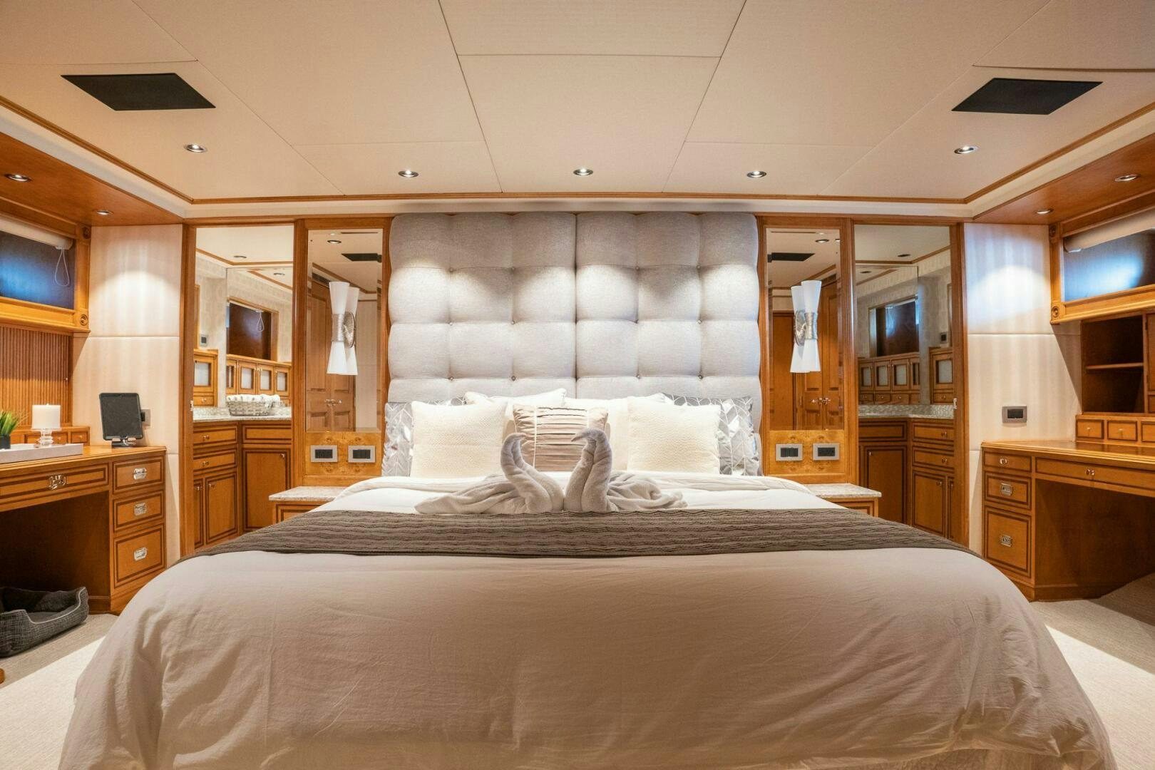 a large bed with a black and white bed spread aboard DOZER Yacht for Sale