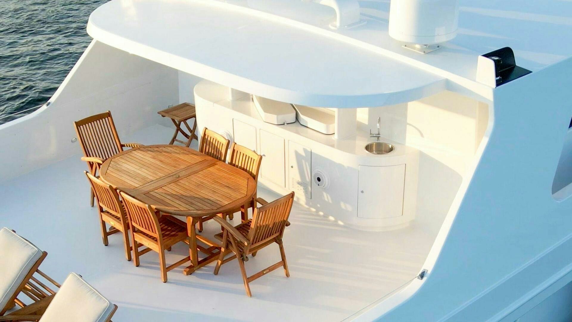 a boat with a sink and chairs aboard DOZER Yacht for Sale