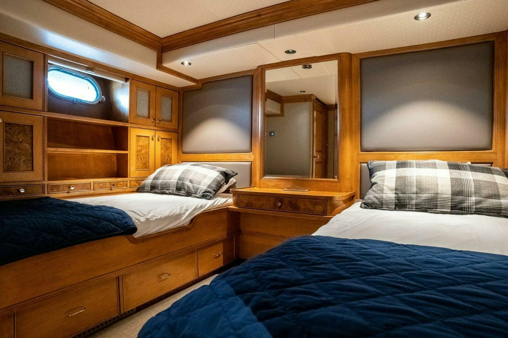 a room with a bed and a television aboard DOZER Yacht for Sale