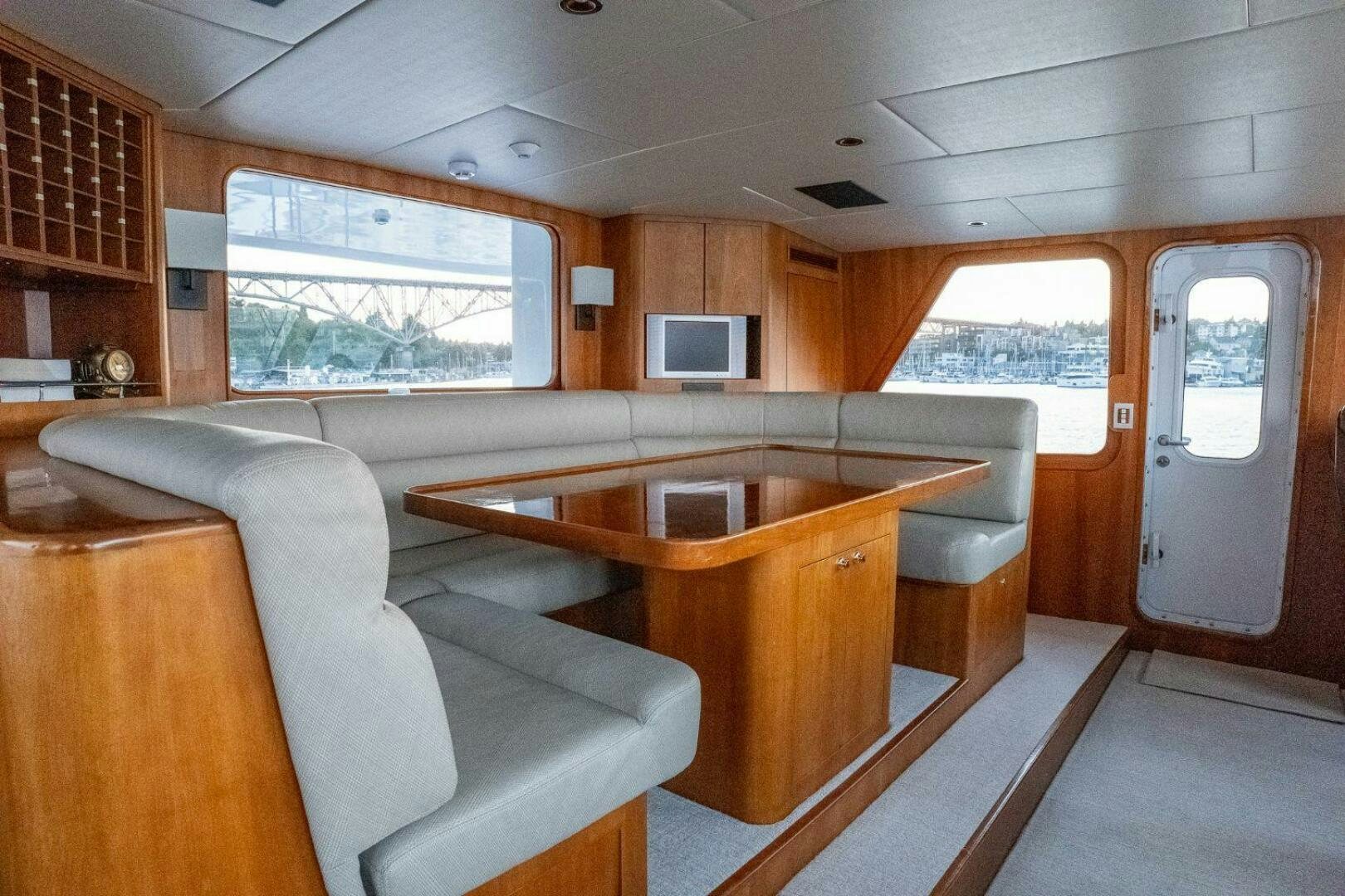 a living room with a table and couches aboard DOZER Yacht for Sale