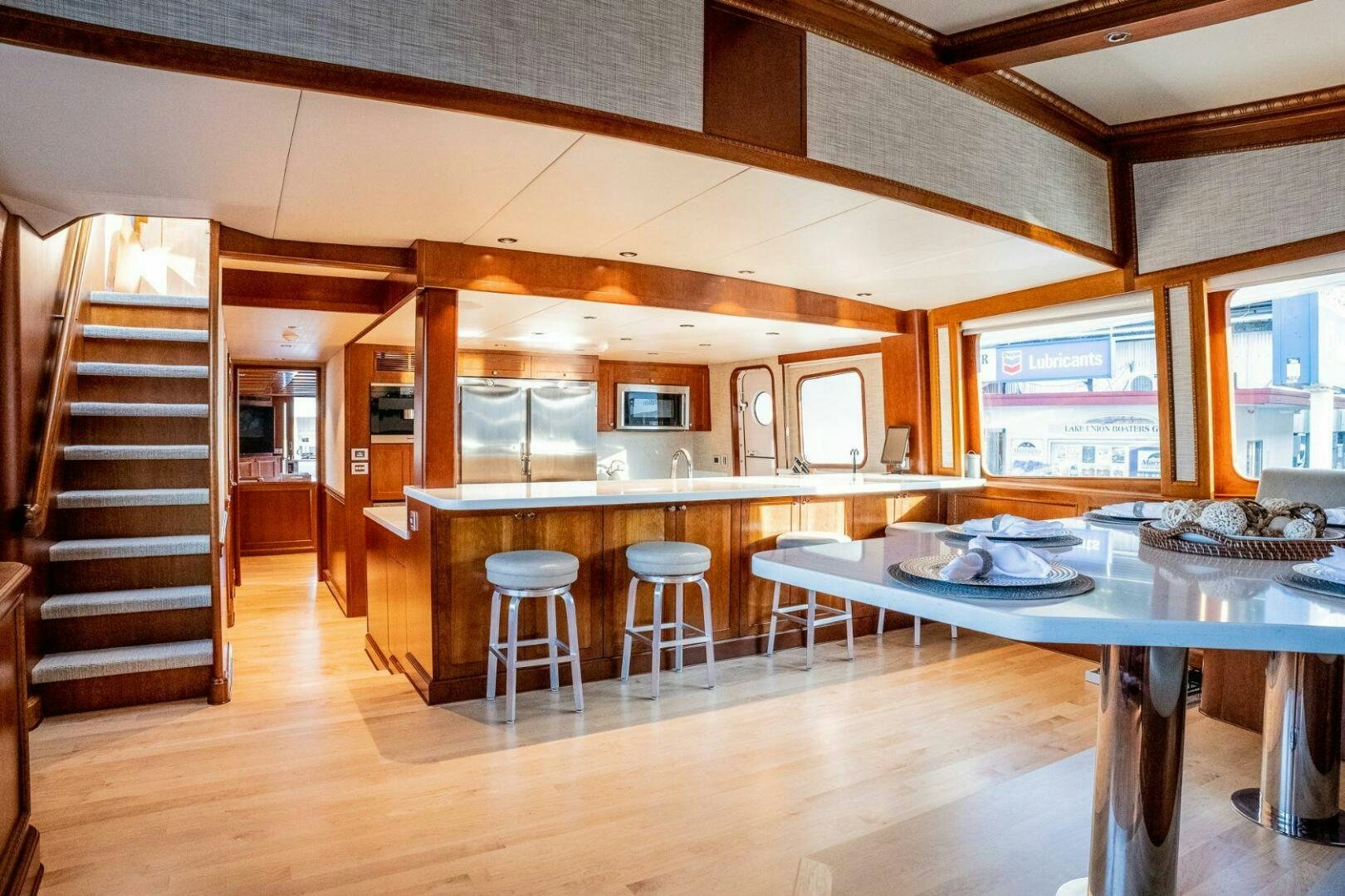 a kitchen with a table and chairs aboard DOZER Yacht for Sale