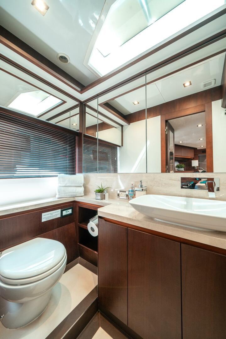 a bathroom with a toilet and a sink aboard OPTIMUS PRIME Yacht for Sale