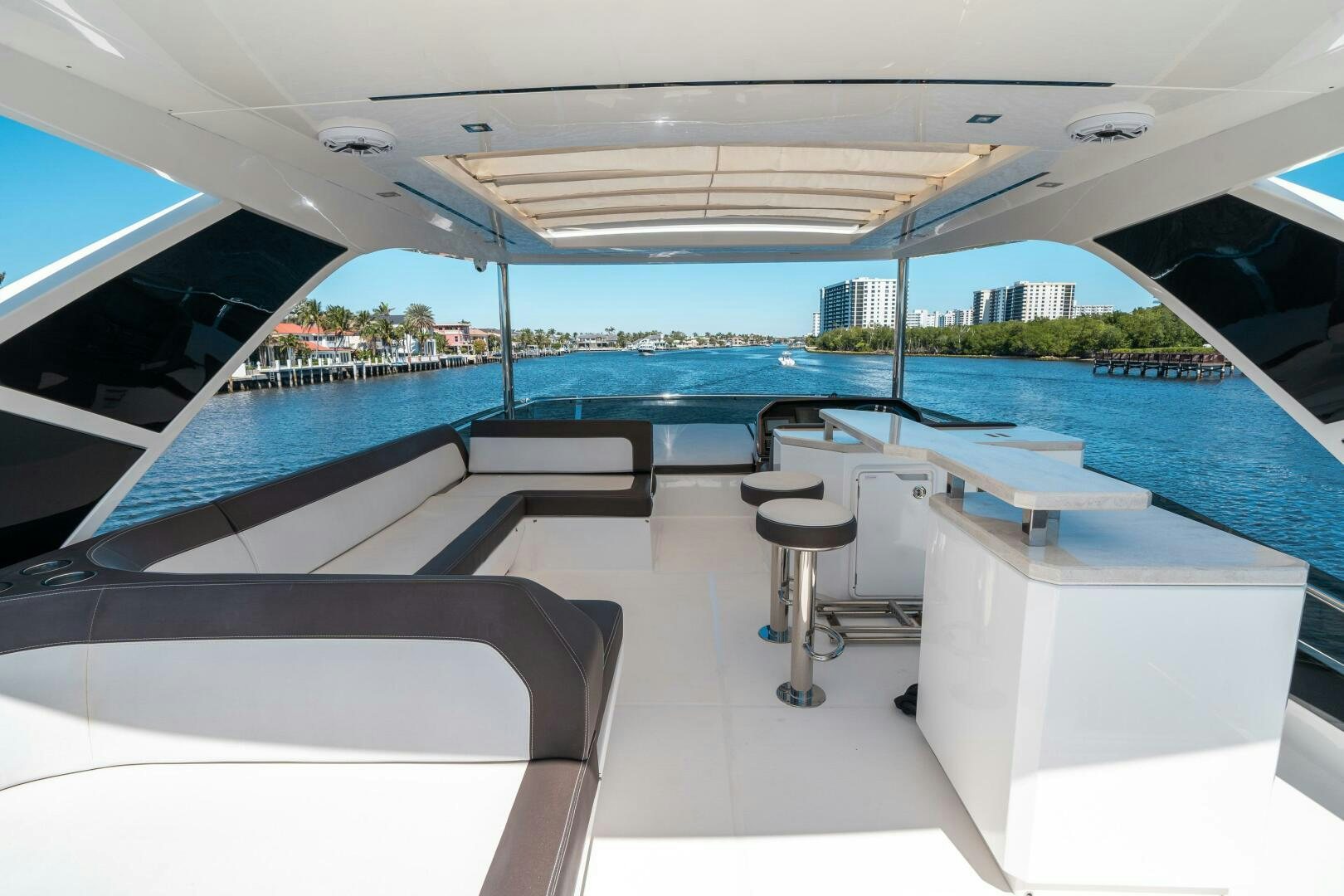 a room with a pool and chairs aboard OPTIMUS PRIME Yacht for Sale