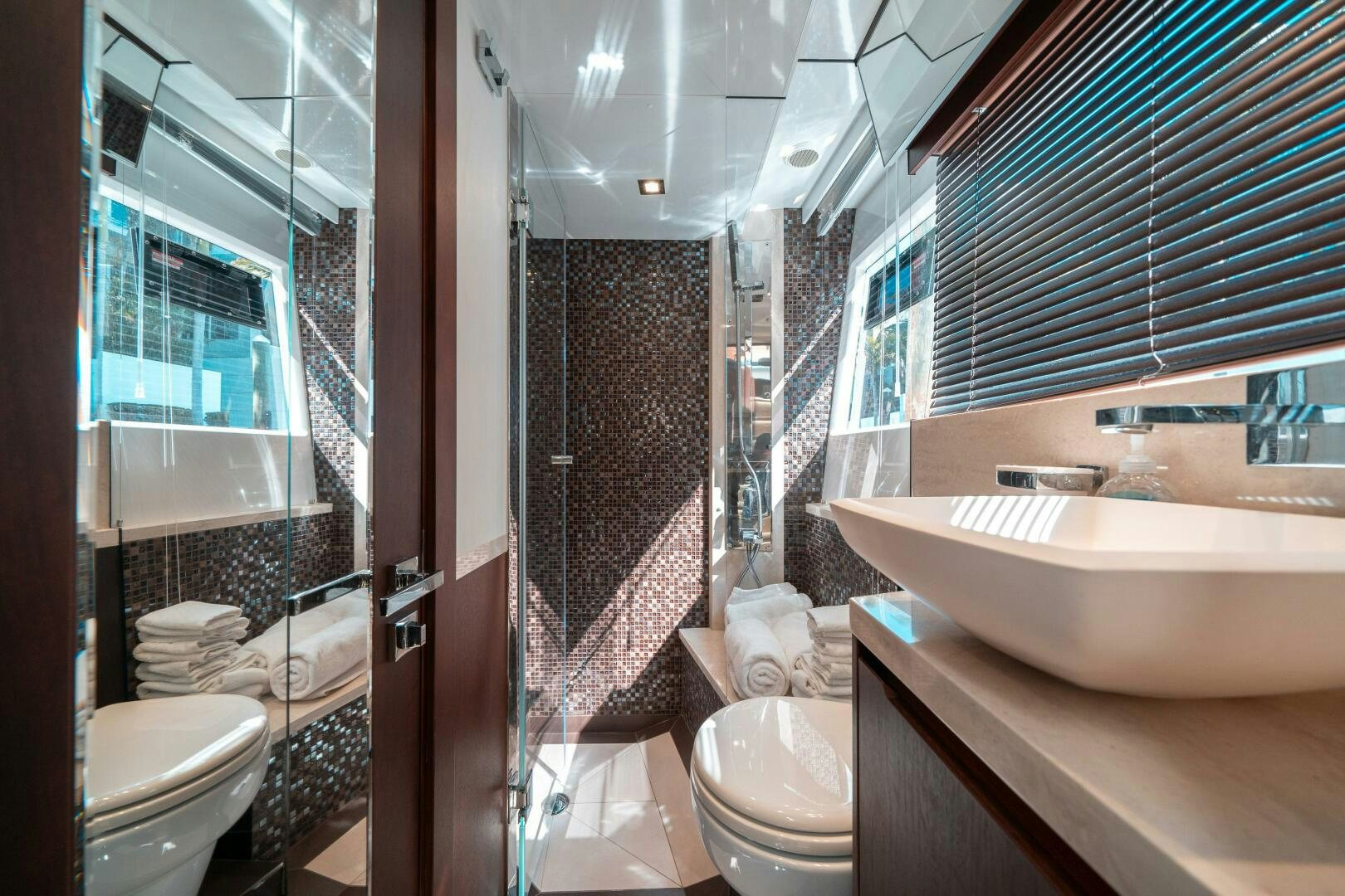 a bathroom with a tub sink and toilet aboard OPTIMUS PRIME Yacht for Sale