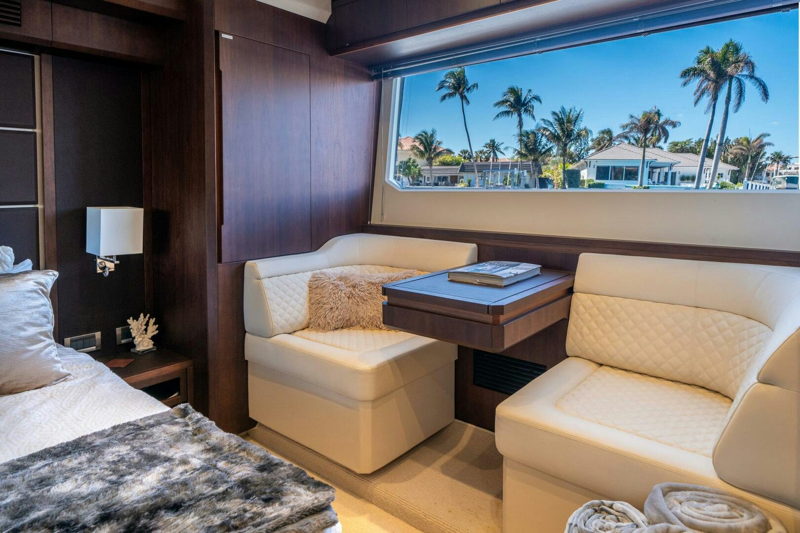 a room with a bed and a table and a window aboard OPTIMUS PRIME Yacht for Sale