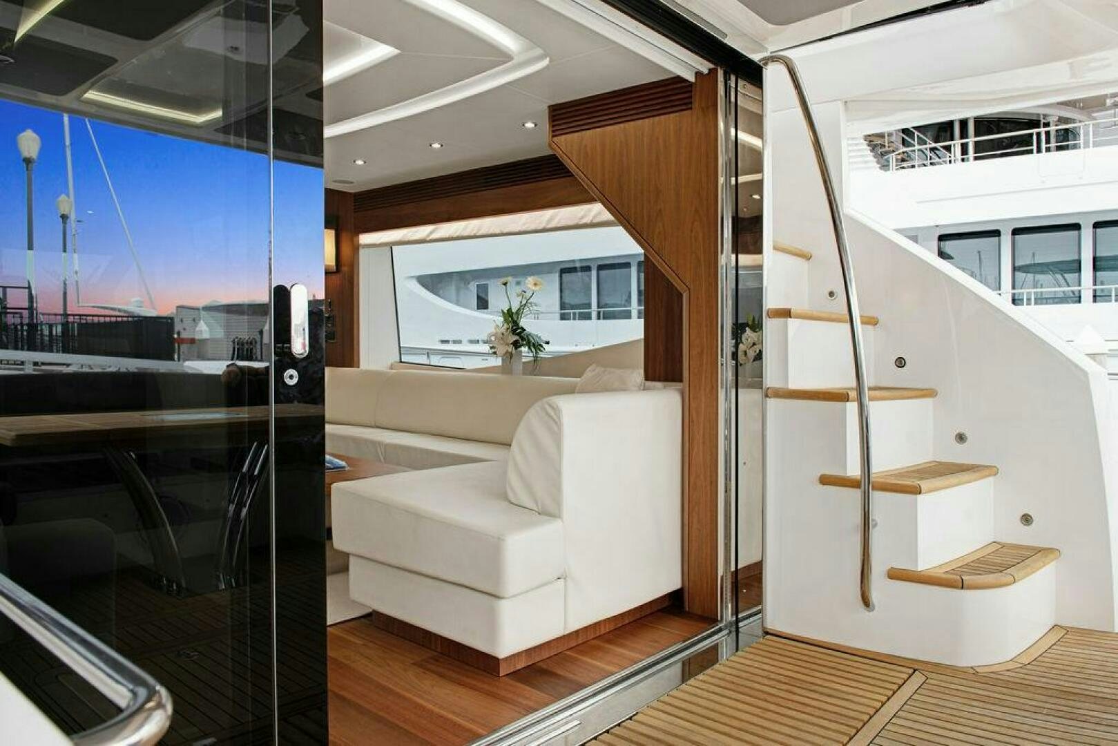 a living room with a large glass wall aboard SEA LA VIE Yacht for Sale