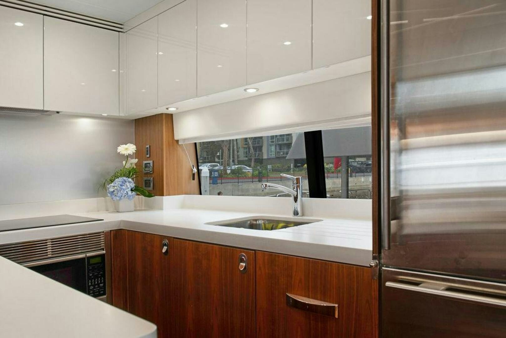 a kitchen with a glass door aboard SEA LA VIE Yacht for Sale