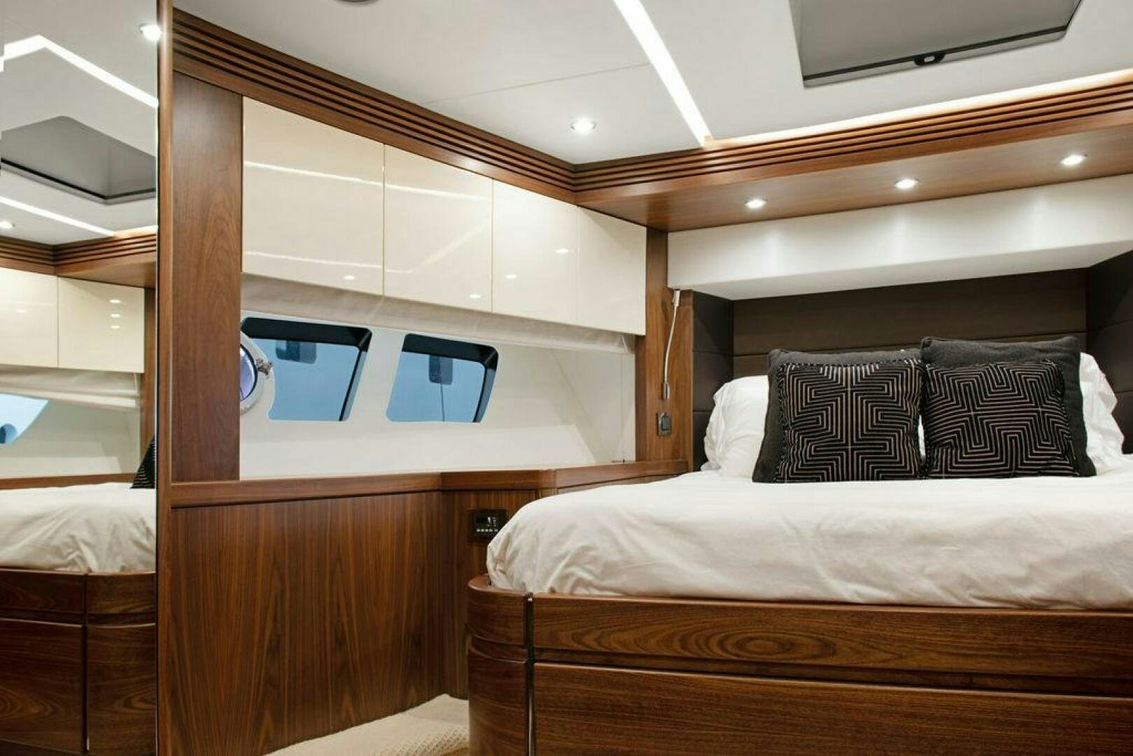 a bed with a wooden headboard aboard SEA LA VIE Yacht for Sale