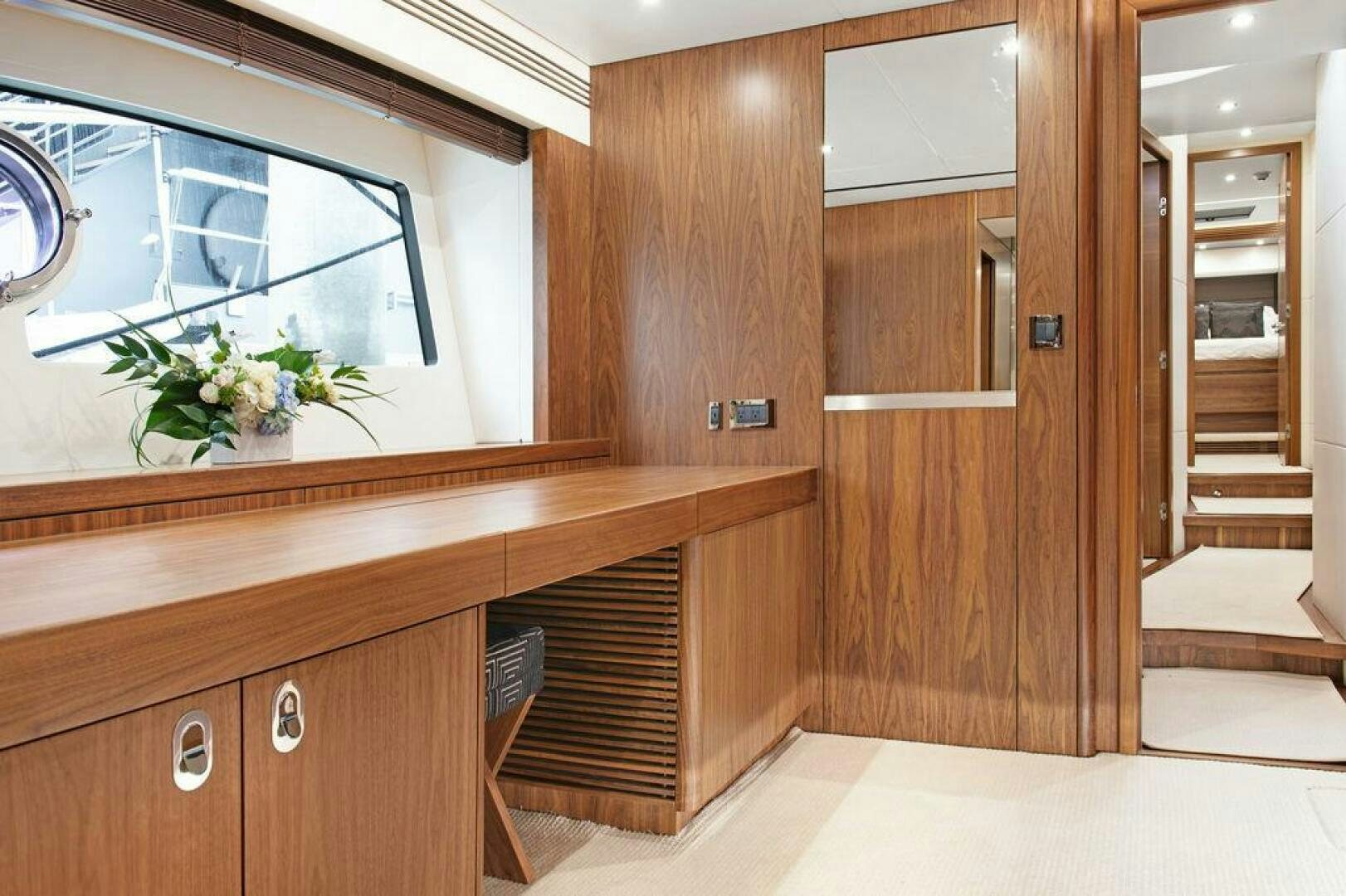 a room with wooden cabinets and a window aboard SEA LA VIE Yacht for Sale