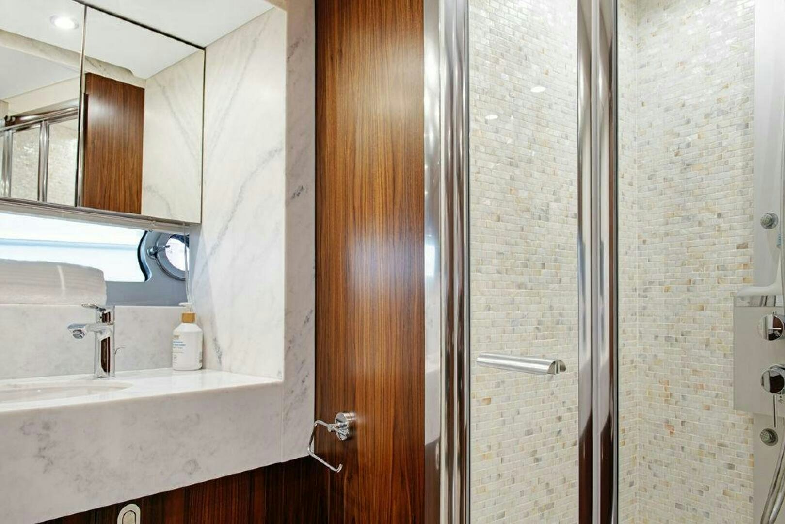 a bathroom with a shower unit and sink aboard SEA LA VIE Yacht for Sale