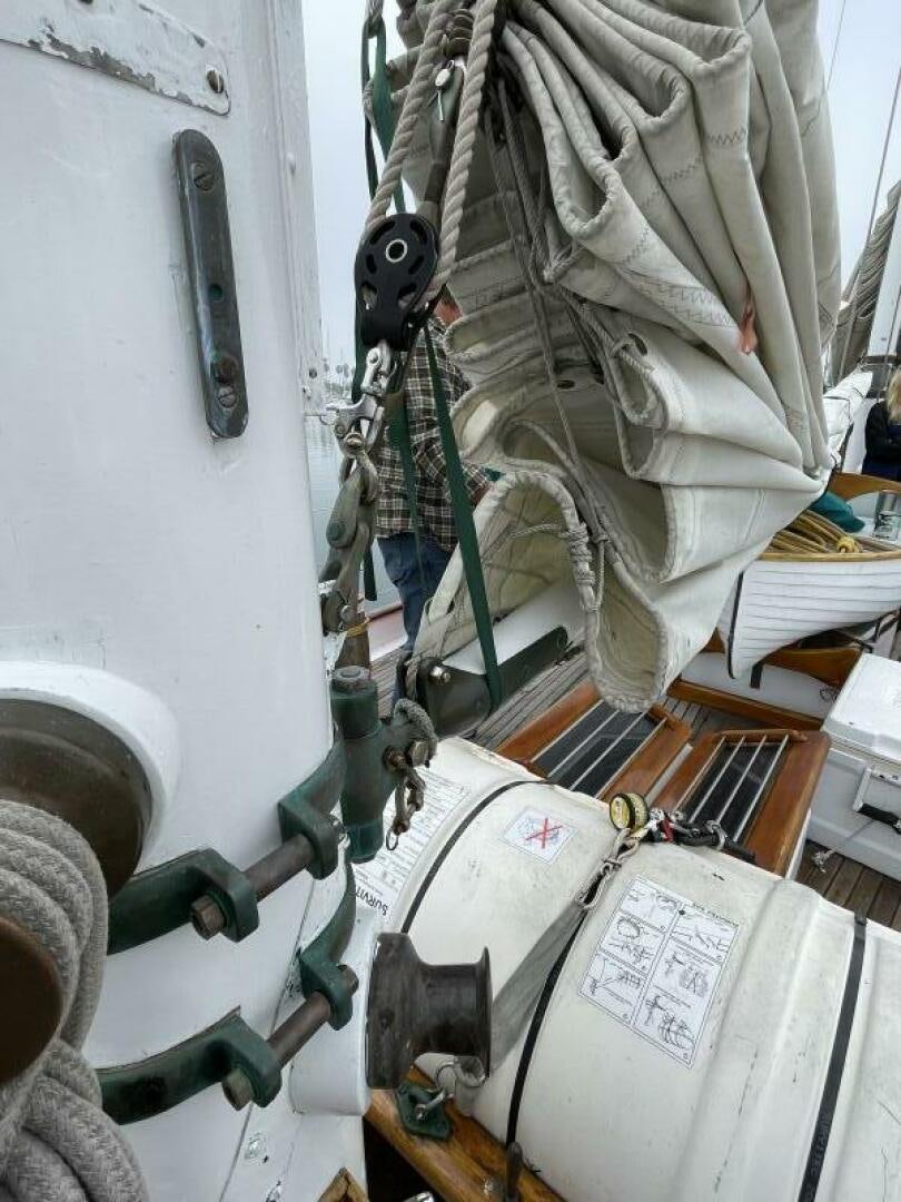 a person climbing a ladder aboard CURLEW Yacht for Sale