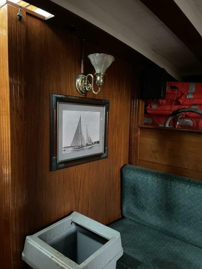 a couch and a television in a room aboard CURLEW Yacht for Sale