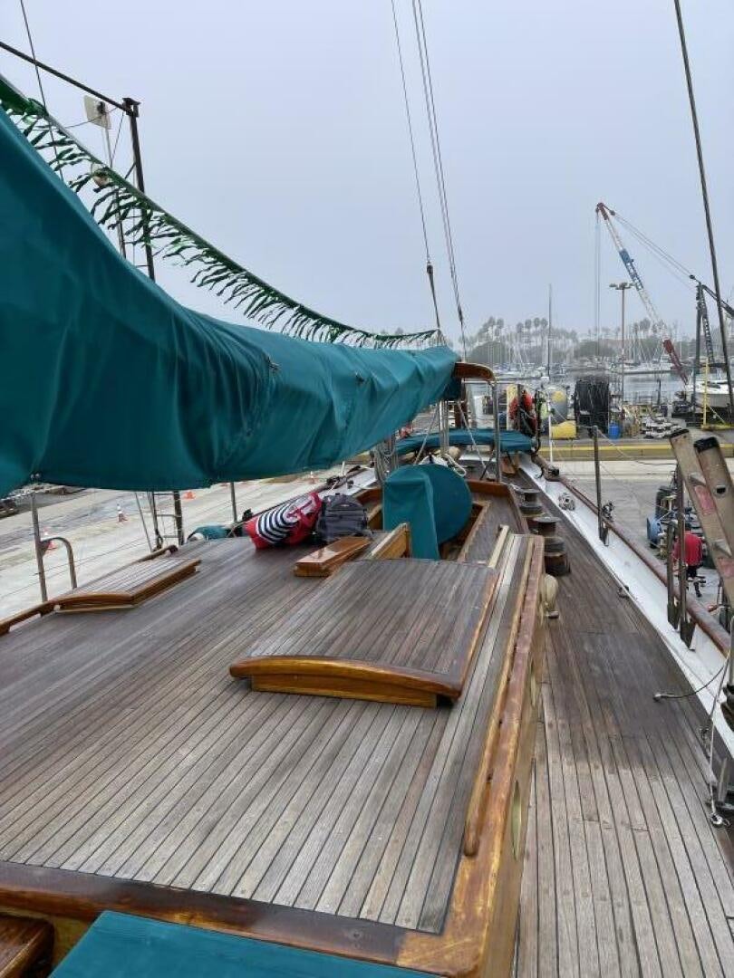 a wooden boat on a dock aboard CURLEW Yacht for Sale