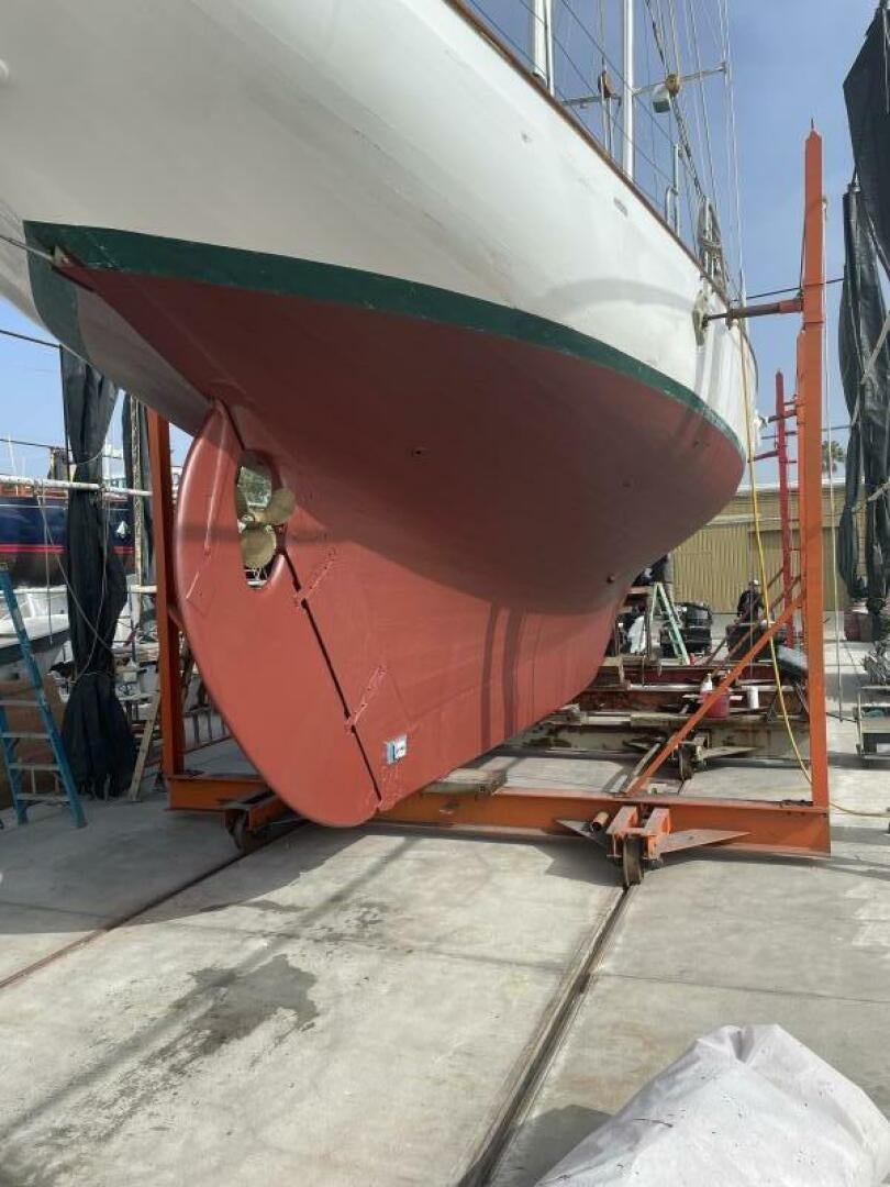 a large colorful boat on a dock aboard CURLEW Yacht for Sale