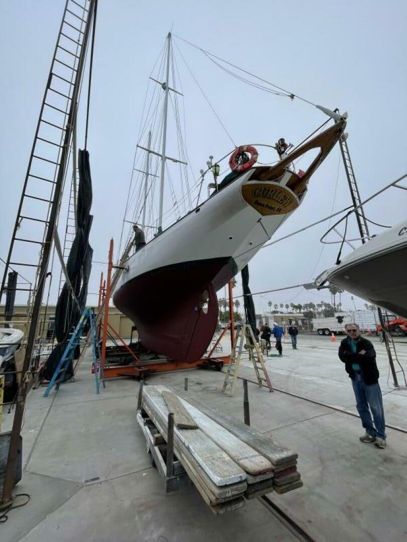 a large boat on a dock aboard CURLEW Yacht for Sale