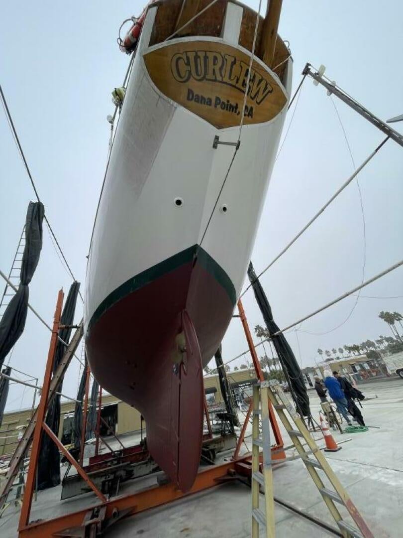 a large white boat with a sign on it aboard CURLEW Yacht for Sale