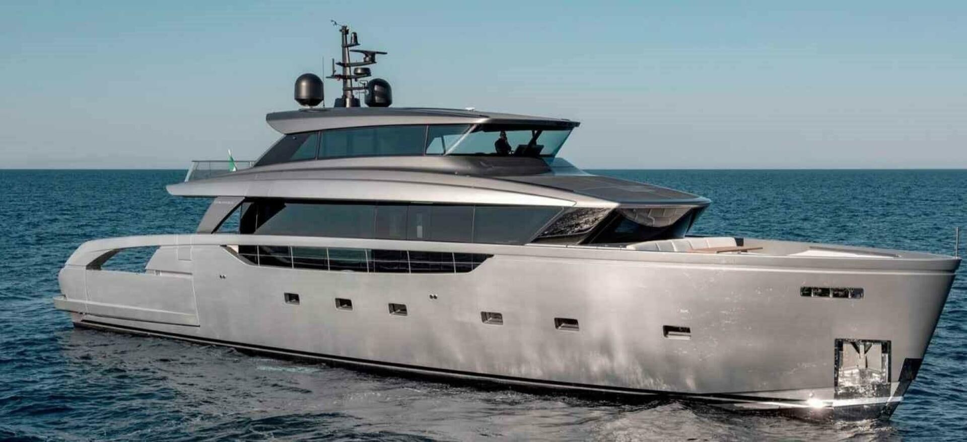 a white yacht on a beach aboard SX100 Yacht for Sale