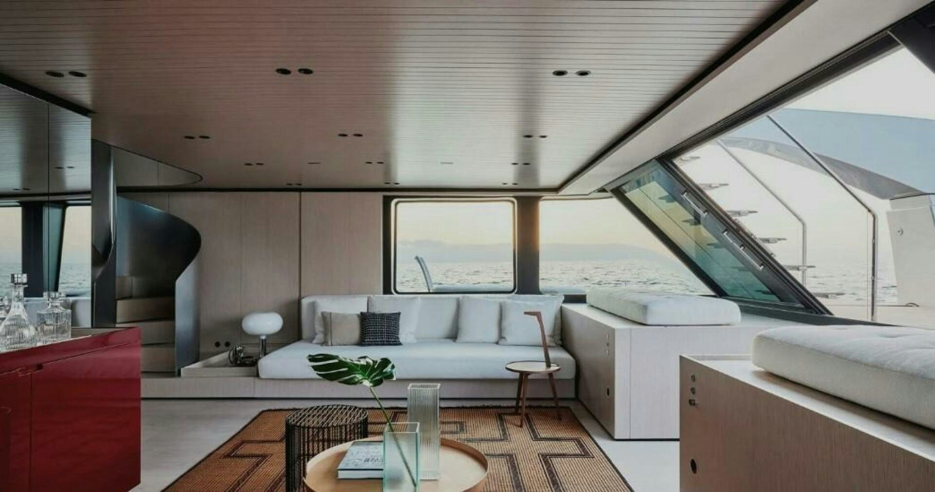 a room with a couch and a table and a window aboard SX100 Yacht for Sale